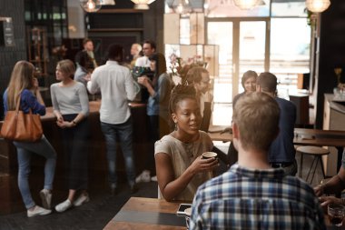 woman talking with friend in coffee shop
