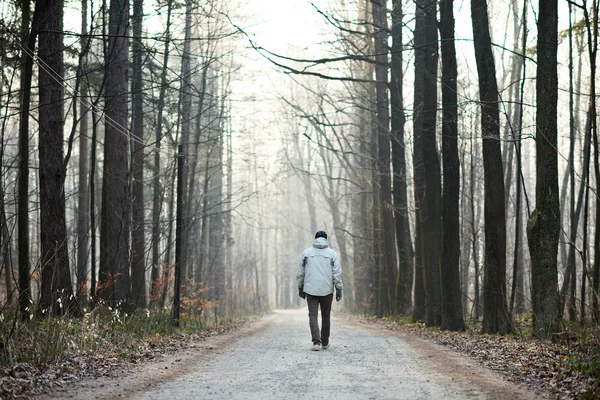 Man walking away down road — Stock Photo, Image