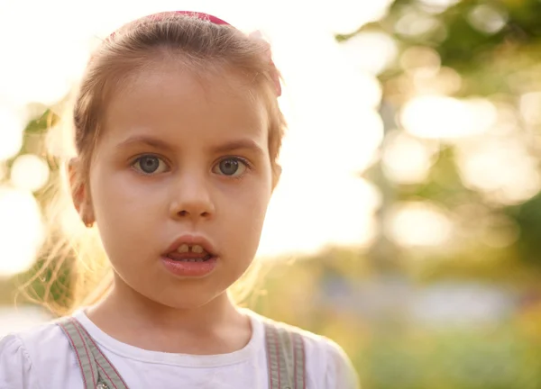 Little girl gazing innocently at camera — Stock Photo, Image