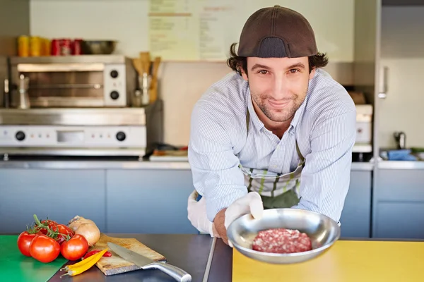 Food entrepeneur holding bowl of meat — Stock Photo, Image
