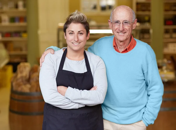 Deli owner and daughter standing together — Stock Photo, Image