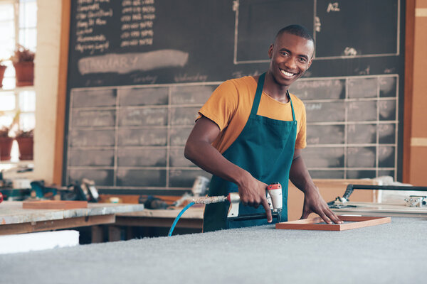 craftsman working in picture framing workshop