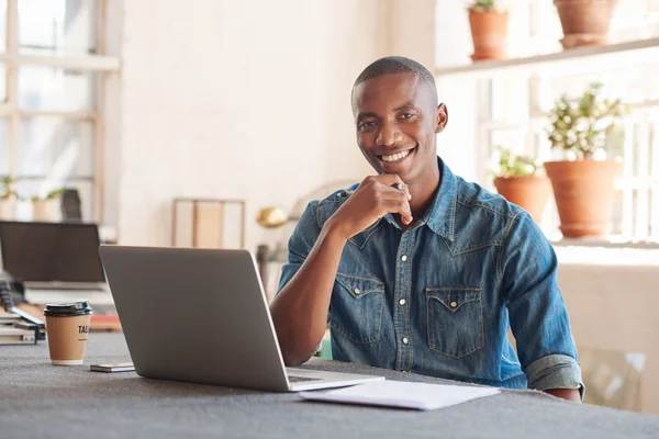 Designer con laptop in monolocale splendidamente illuminato — Foto Stock