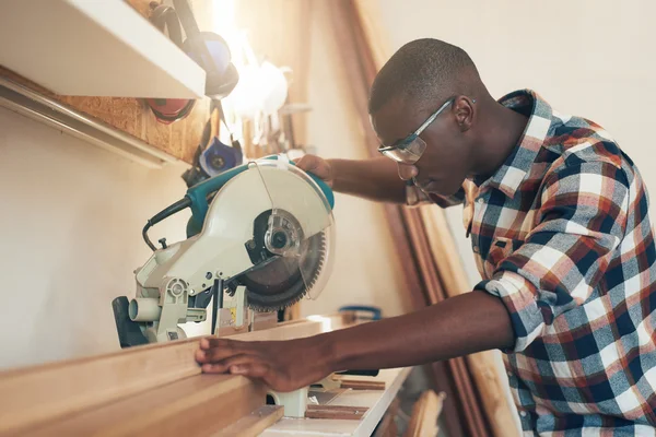 Artisan working with chop saw in workshop — Stock Photo, Image