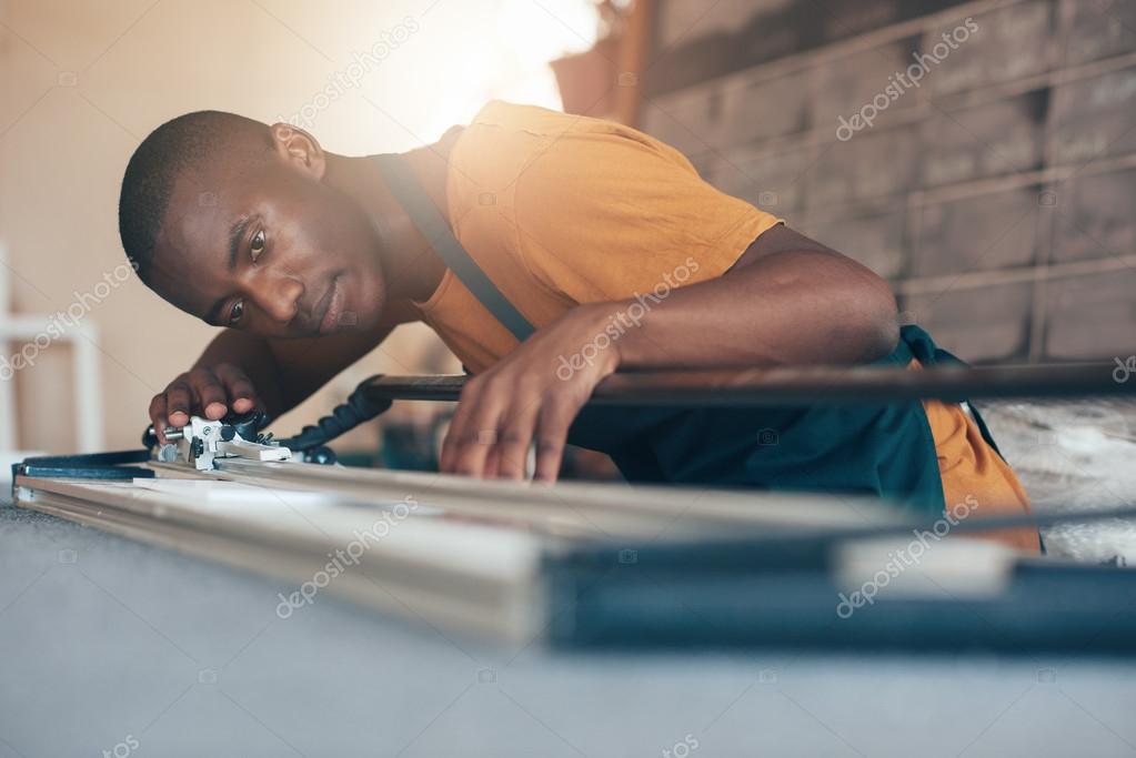 African artisan working with cutting tool — Stock Photo © mavoimages