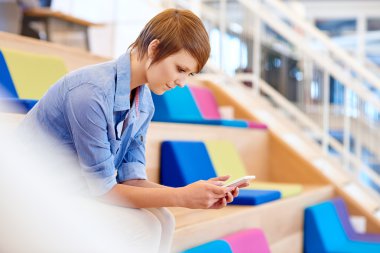 woman in coworking space with colourful cushions
