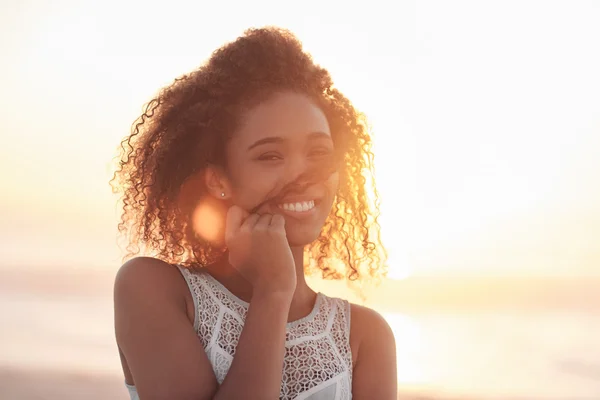 Mujer de pie en la playa al atardecer — Foto de Stock