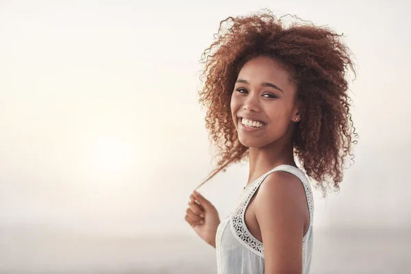 Mujer de pie en la playa al atardecer — Foto de Stock