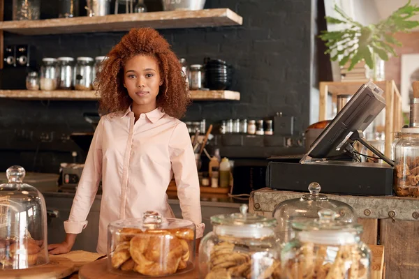 Woman standing behind counter of cafe — Stock Photo, Image