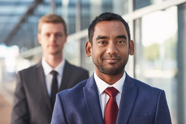 Businessman standing with colleague in background — Stock Photo, Image