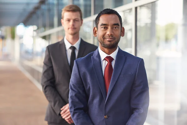 Businessman standing with colleague in background — Stock Photo, Image