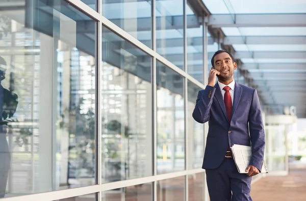 Empresário falando no celular enquanto caminha — Fotografia de Stock