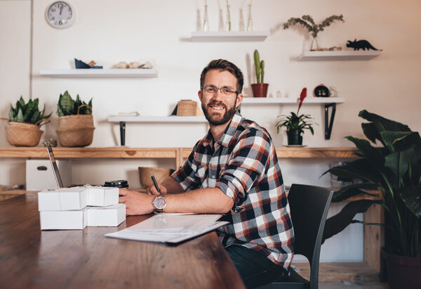 entrepreneur sitting at table using laptop