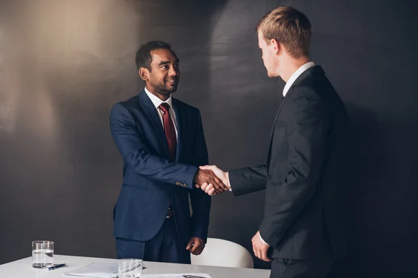 businessmen shaking hands after successful negotiation