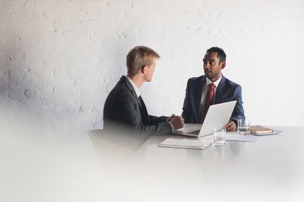 Businessmen in suits talking together over laptop — Stock Photo, Image