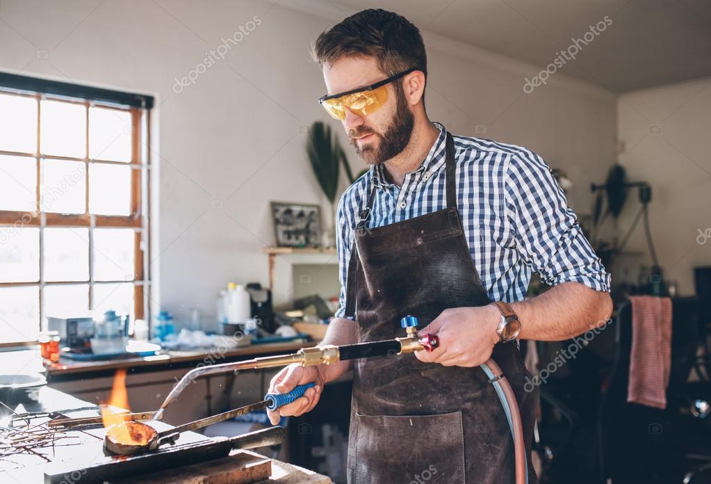 Jeweler using torch to melt metal — Stock Photo © mavoimages 121943734