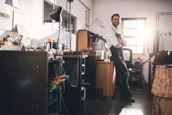 Jeweler standing in workshop full of tools — Stock Photo, Image