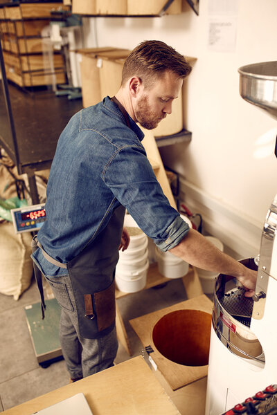 man working with roasting machine