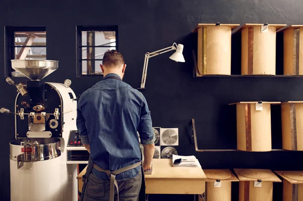 Homem que trabalha no roastery do café — Fotografia de Stock