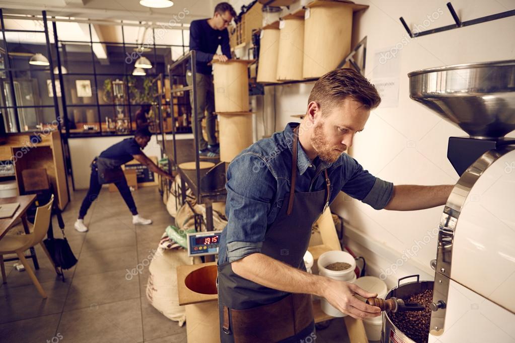 Men working in modern coffee roastery Stock Photo by ©mavoimages 97006240