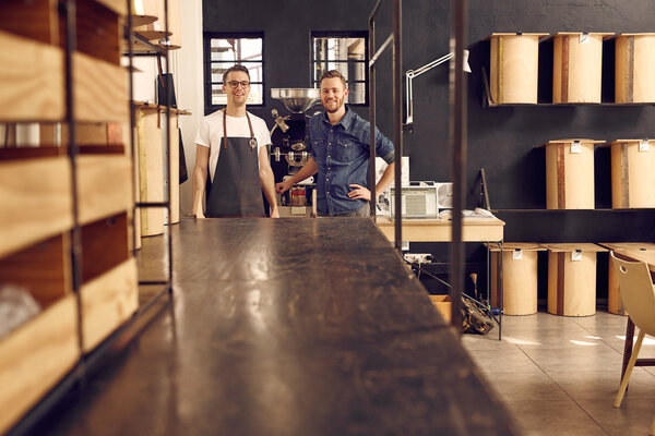 men in roast coffee beans workspace