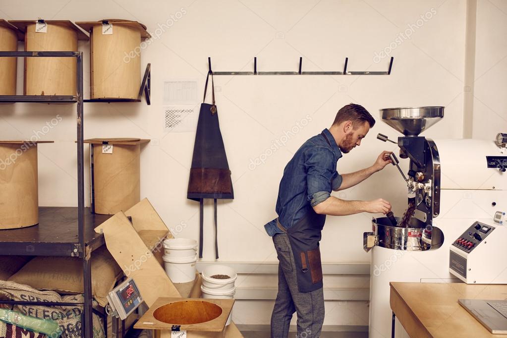 Man working with roasting machine — Stock Photo © mavoimages 97013448