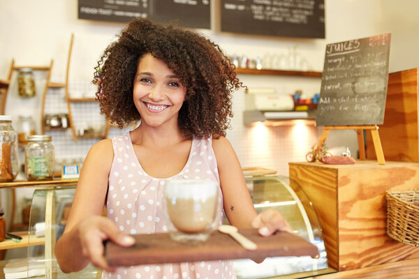 waitress holding wooden tray with Latte