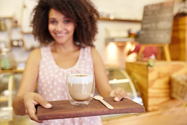 Waitress holding wooden tray with Latte — Stock Photo, Image