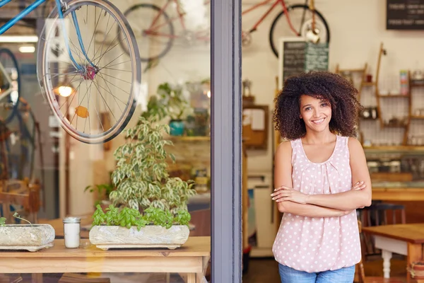 Coffee shop owner standing in door — Stock Photo, Image