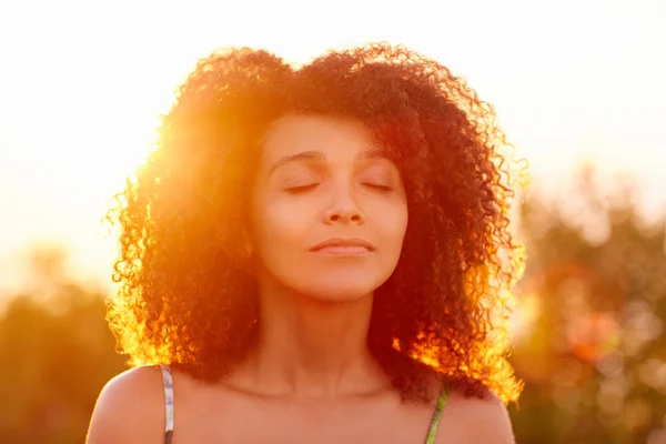 Woman closing eyes on summer evening — Stock Photo, Image