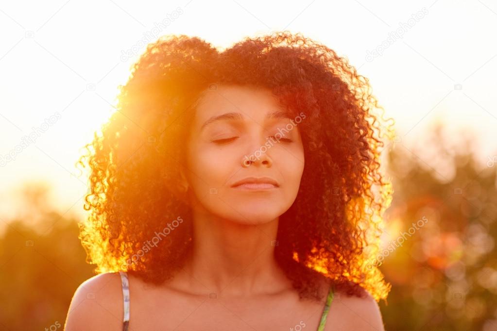 woman closing eyes on summer evening