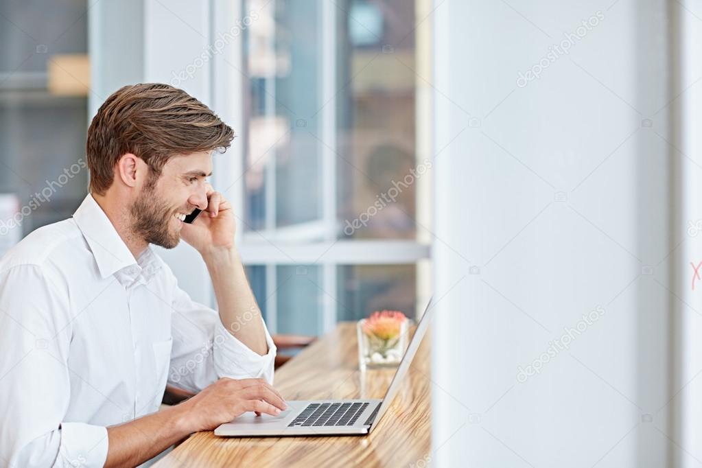 businessman engaged in conversation on laptop