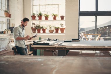 business owner checking stock on clipboard