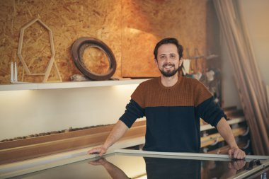 craftsman in design studio looking positive