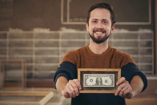 Entrepreneur showing framed bank note — Stock Photo, Image