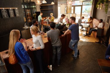People waiting at cafe counter for orders clipart