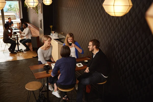 Friends having meeting in coffee shop — Stock Photo, Image