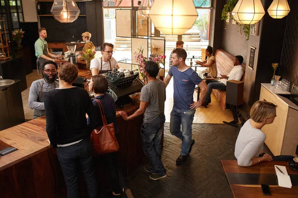 Baristas standing at counter placing orders — Stock Photo, Image