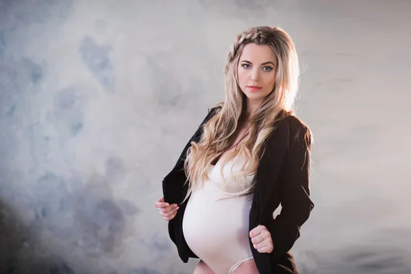 Portrait of a beautiful pregnant woman in white lingerie and long hair — Stock Photo, Image