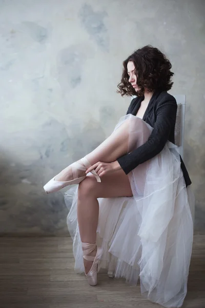Young ballerina or dancer girl wear her ballet shoes