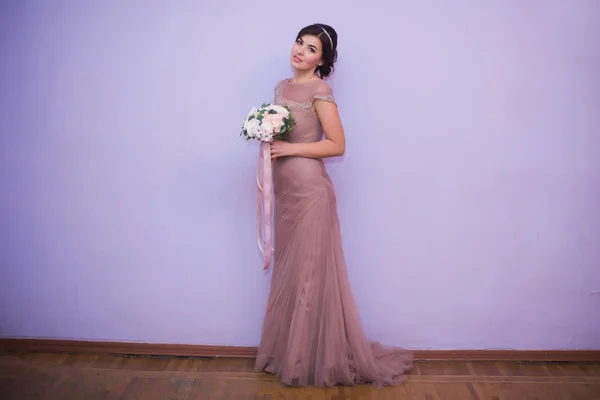 Retrato de una joven morena en un hermoso vestido con maquillaje y peinado —  Fotos de Stock