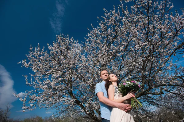 Young couple in love outdoor on blue sky background. Stock Image