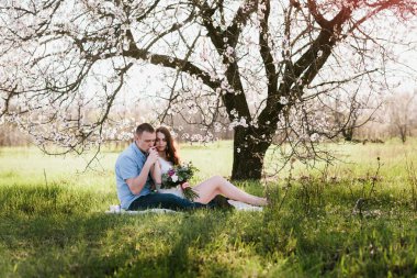 Young couple sitting in spring nature close-up portrait
