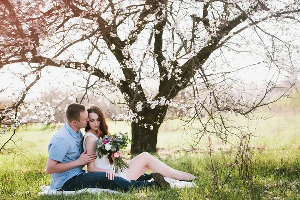 Young couple sitting in spring nature close-up portrait — Stock Photo, Image