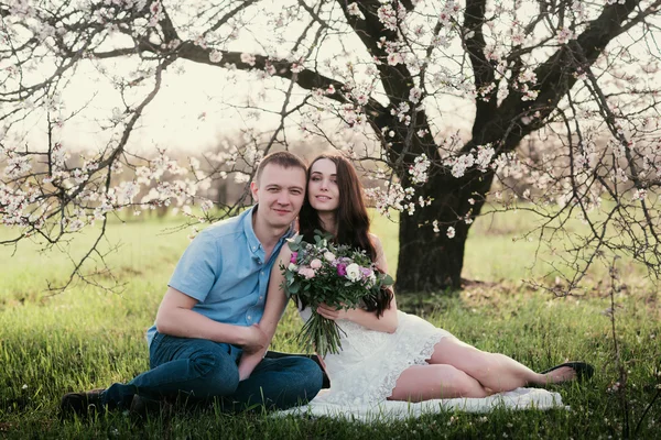 Young couple sitting in spring nature close-up portrait