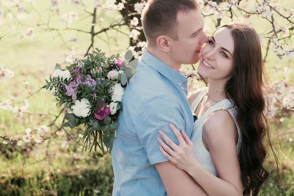 Young couple in love outdoor on blue sky background. — Stockfoto