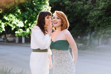 İki güzel kadın konuşuyor, gülüyor