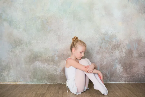 Little ballet dancer sitting white swimsuit, dance, sports, healthy lifestyle, ballet — Stock Photo, Image