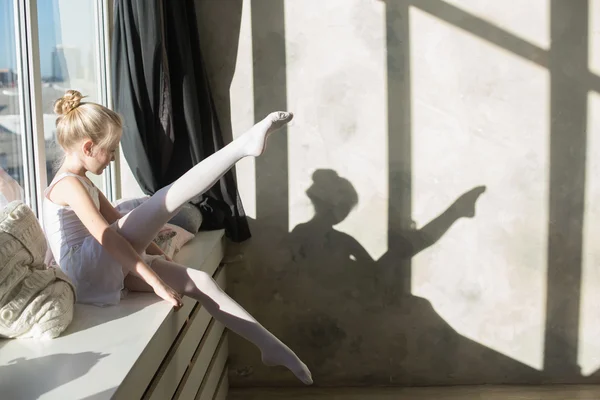 Little ballet dancer sitting white swimsuit — Stock Photo, Image