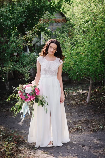 Portrait of a beautiful girl with a bouquet of flowers